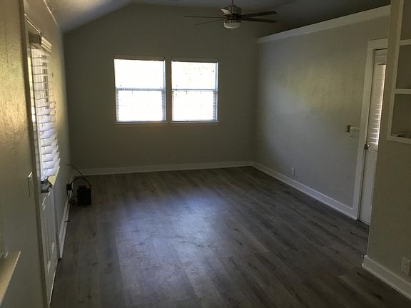 living area with front entry to right and door to rear porch on left