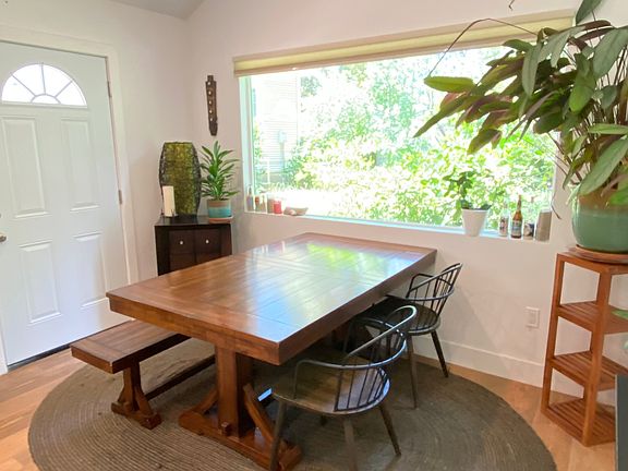 Open living/dining space with doors to private deck