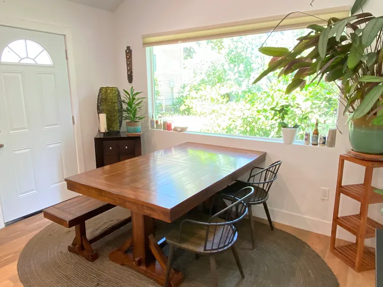 Open living/dining space with doors to private deck