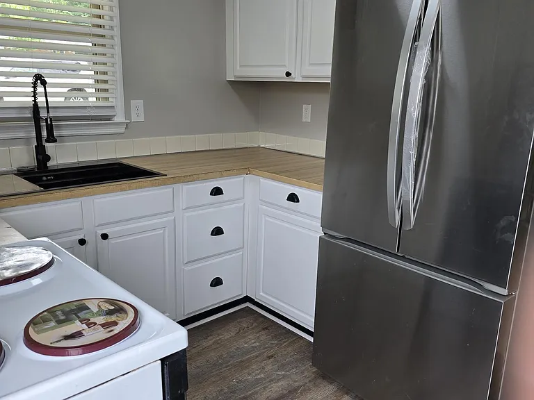 Additional view of kitchen: compact but convenient and low maintenance. New kitchen flooring visible in this photo (waterproof). Also in both bedrooms.