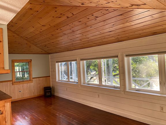 Living Room with lake facing windows and pull down shades.