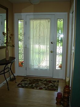 br A view of the attractive front door, and the foyer of the home.br br Maple wood floors in the Foyer, Kitchen, and Dining Room.