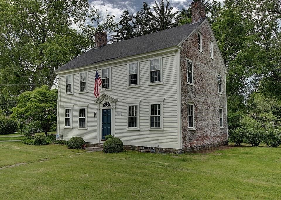 Exterior front.  Georgian Colonial with brick sides and clapboard front and back.