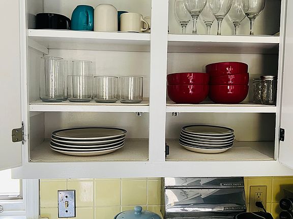 Fully stocked kitchen including small coffee maker, toaster, electric tea kettle, and microwave.