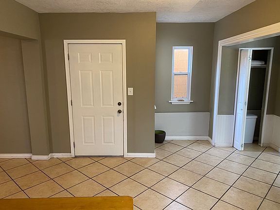 B unit entrance, Kitchen to right, Living room and garage entrance to the left .
