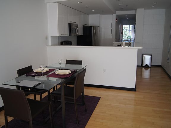 Living area facing kitchen and hallway