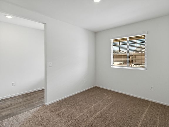 Front den provides space for a home office or study.