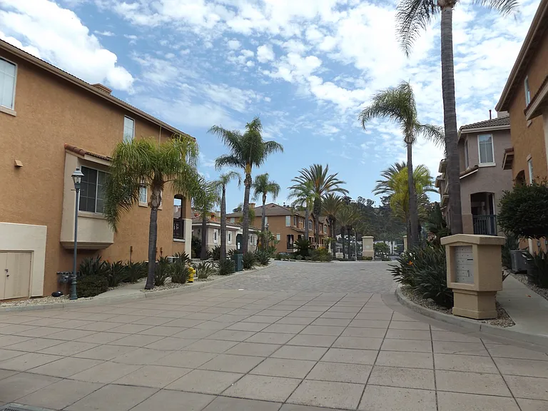 Part of the drive way circulation looking westward with the light colored pool house to the left
