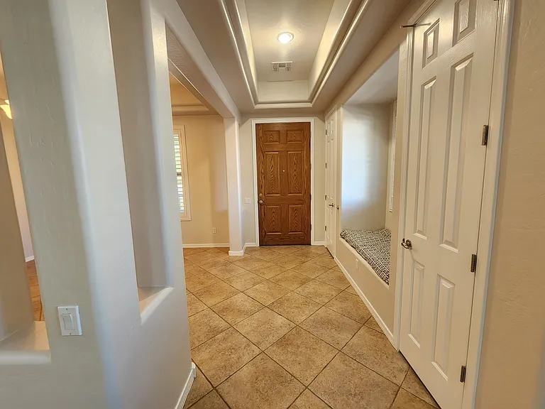 Looking back at the front door. Two storage closets and a sitting area.