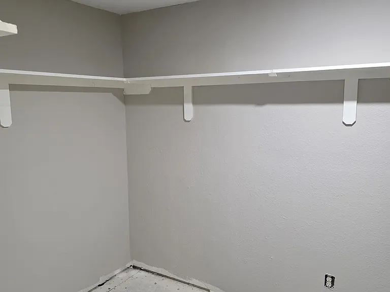 Large walk-in master closet with shelving
