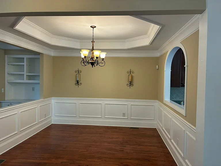Dining Room with tray ceiling and wood molding