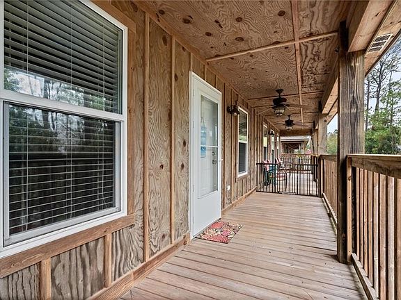 Wooden terrace featuring ceiling fan