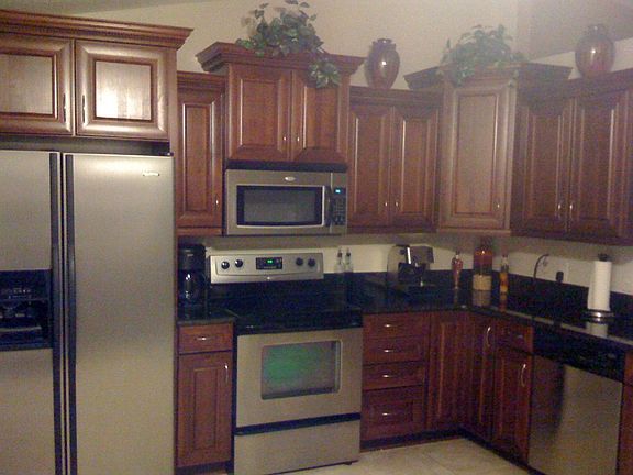 New open kitchen with cherry cabinets, stainless appliances & granite counter