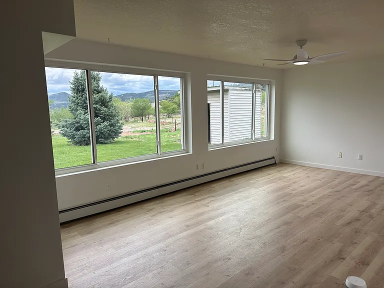 First floor living room with views out to grassy yard. All new flooring