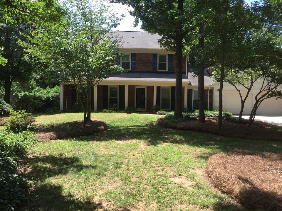 Front of house w porch. Treed lot.