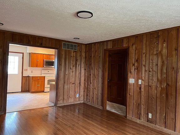 Rough-sawn cedar walled family room. view to kitchen.