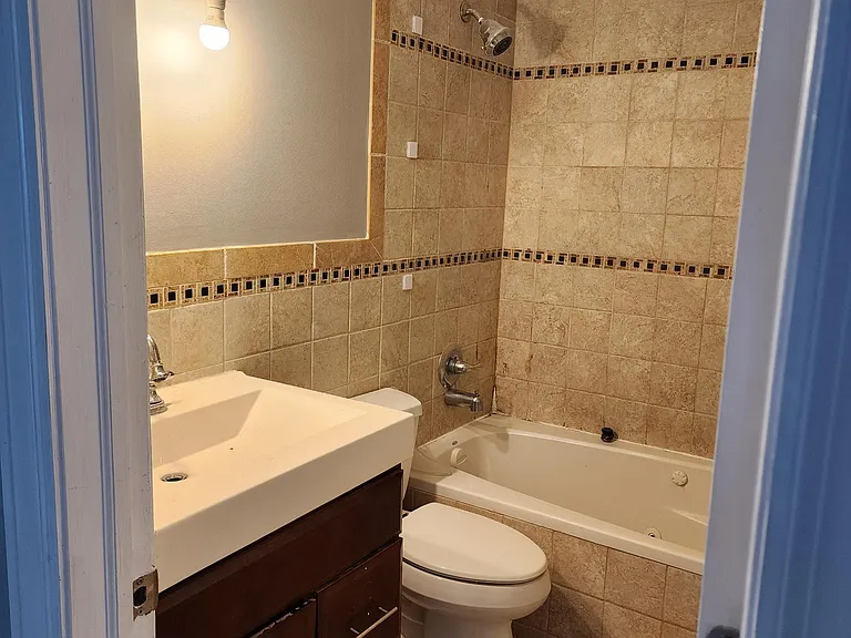 First Floor: Hallway bath, with Jacuzzi tub.