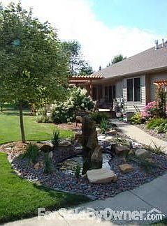 Koi pond with fountain : Concrete sidewalk winds from front & back of garage to Garden Shed to Trex 