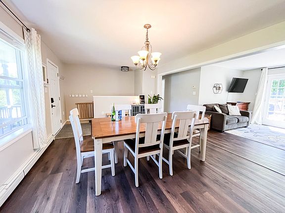 Open concept dining room with large table and big windows make this a bright room all day long