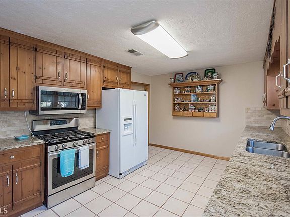 new stove, granite counter top. backsplash all in 2017  Tile floors.