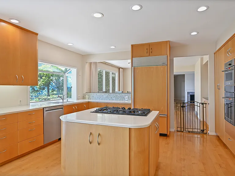 Kitchen located east of main living and dining rooms