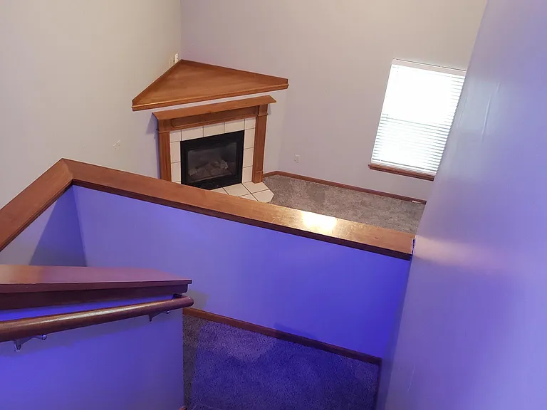 Living room fireplace from top of stairs vantage point