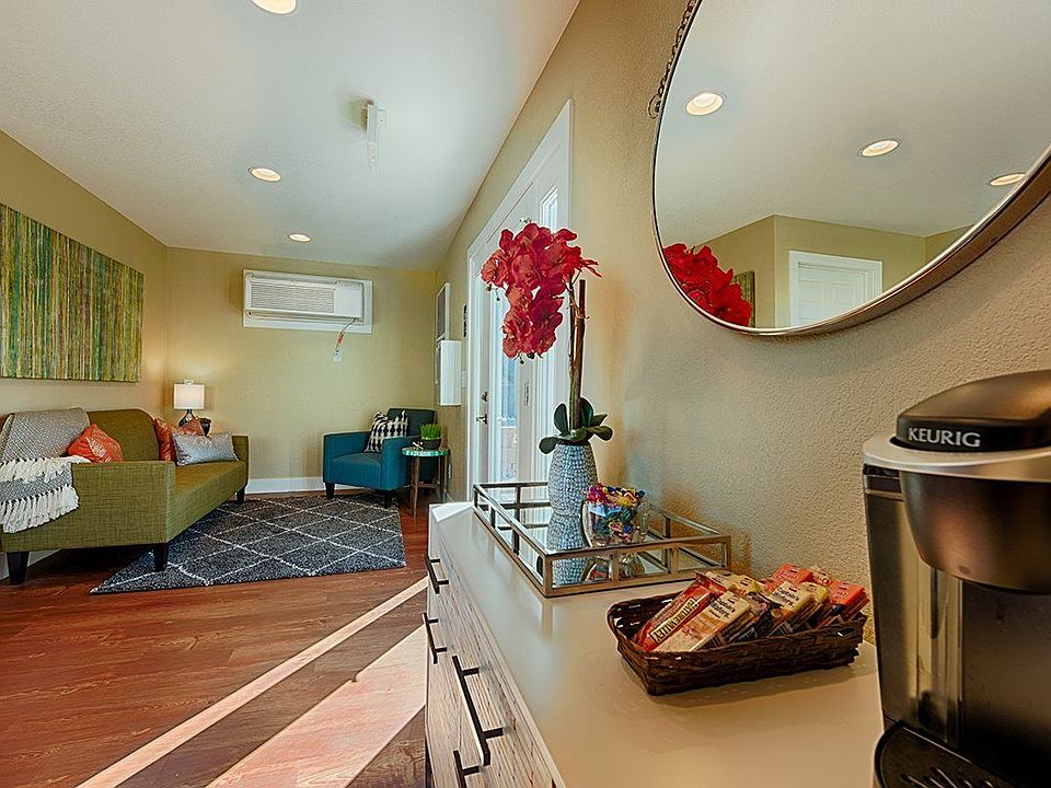Spacious resident lounge area with wood-style vinyl plank flooring and a coffee bar.