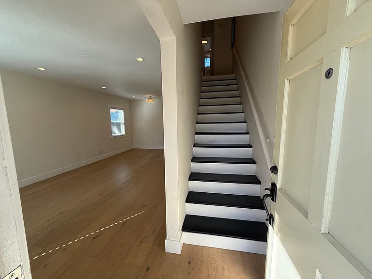 Stairway to upstairs. Both bedrooms and bathroom are upstairs.