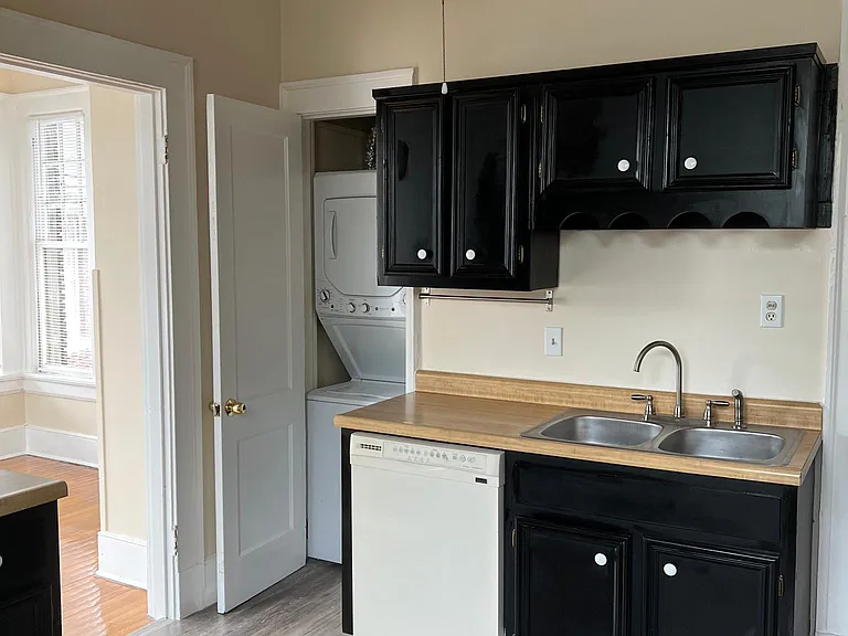 Kitchen view#2 shows more cabinets, dishwasher and stackable washer/dryer closet!