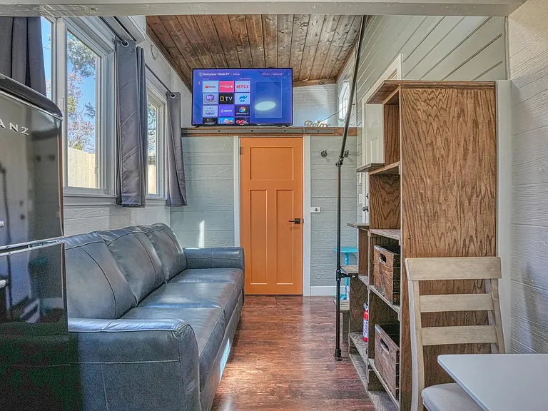 TV can be seen from all areas of tiny home and bed
