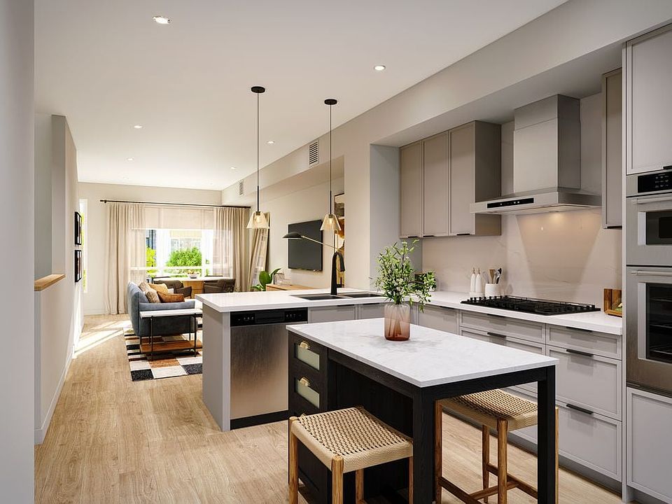 Signature Collection I 3-Bedroom Townhome kitchen with light grey cabinetry, marble quartz countertop and backsplash, upgraded stainless steel appliances, and hard-surface vinyl plank flooring throughout (Rendering)