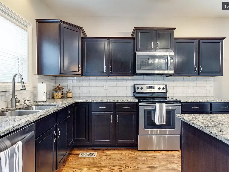 Dishwasher, oven, microwave and double basin sink with disposal. Ample of cabinet and counter space.