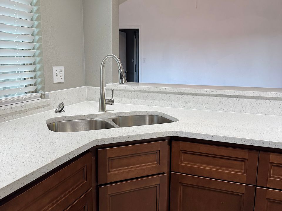 corner sink allows for viewing out the window to backyard or into living room