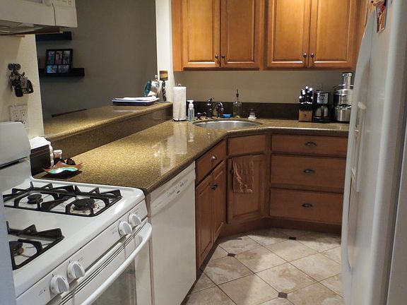 Kitchen opens to family room and includes refrigerator, dishwasher, oven and microwave.