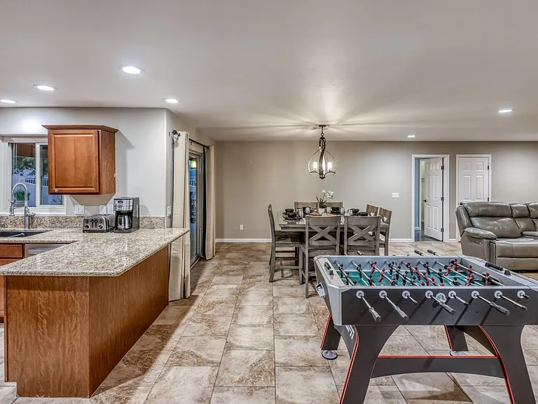 Open kitchen with granite countertops overlooking dining and living areas for seamless flow.