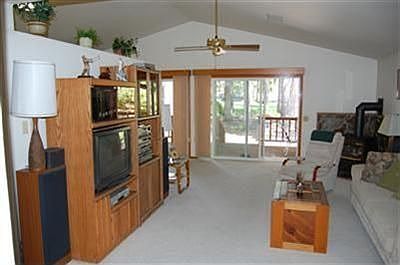 Open floor plan with vaulted ceiling in living room and view of golf course.