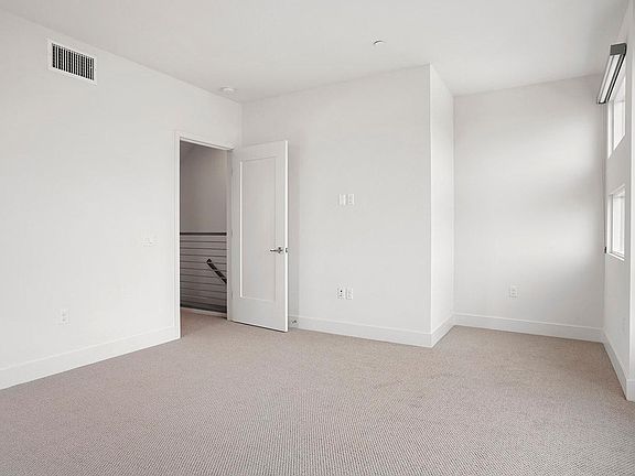 Primary suite has lots of light and beautiful blinds when privacy is needed