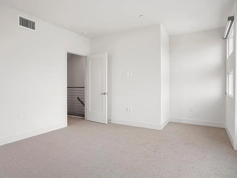 Primary suite has lots of light and beautiful blinds when privacy is needed