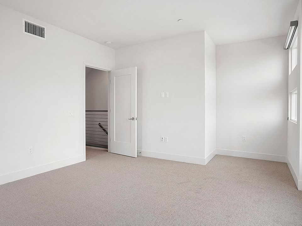 Primary suite has lots of light and beautiful blinds when privacy is needed