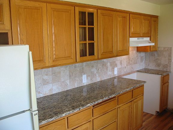 Remodeled kitchen with new granite, new tile backsplash, custom oak cabinets