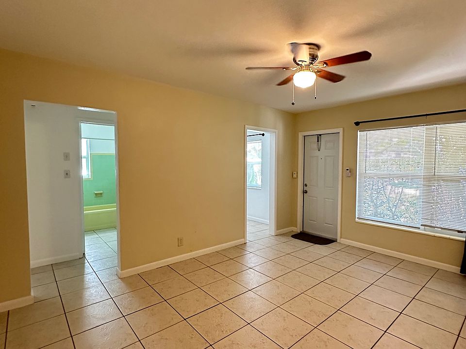 View in the living room to the front door and vision of corridor to bathroom and bedroom.