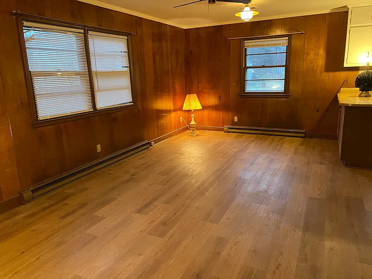 Large paneled den with just installed Luxury Vinyl Plank. Half bath near door. Side entrance to carport. New lighting being installed. Adjoins kitchen.