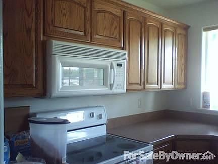 Easy kitchen with all amenities : Two counters, sink at angle with great windows & light; micro, sto