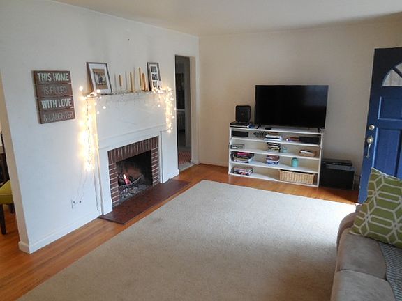 Living Room. Hardwood Floor; Wood Fireplace is Active (area