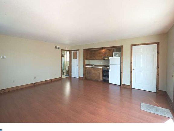 Open living room with kitchenette; small island (shown in separate photo) with storage, work space and seating added in 2019; new refrigerator in 2020