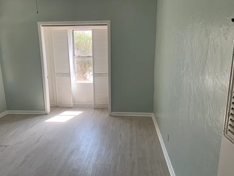 Master bedroom, closet space to the right and left of the window.