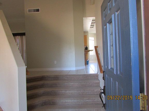 Entry way. To the left is the living room. Up and to the left is the dining room. Straight ahead is the kitchen.