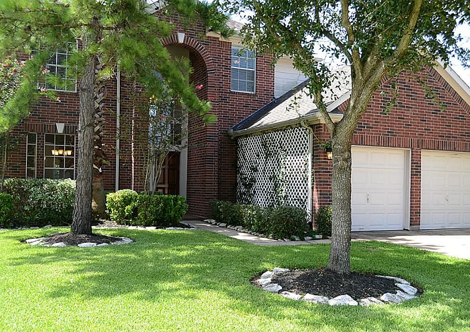 Beautiful setting for this wonderful Two Story with oak trees, pine trees and lush landscaping