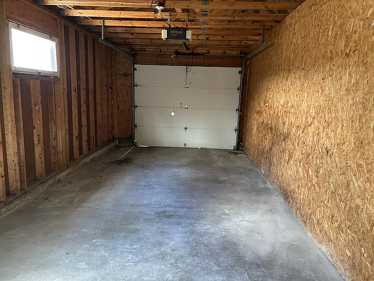 View from door into the apartment. Closed garage with garage door opener.