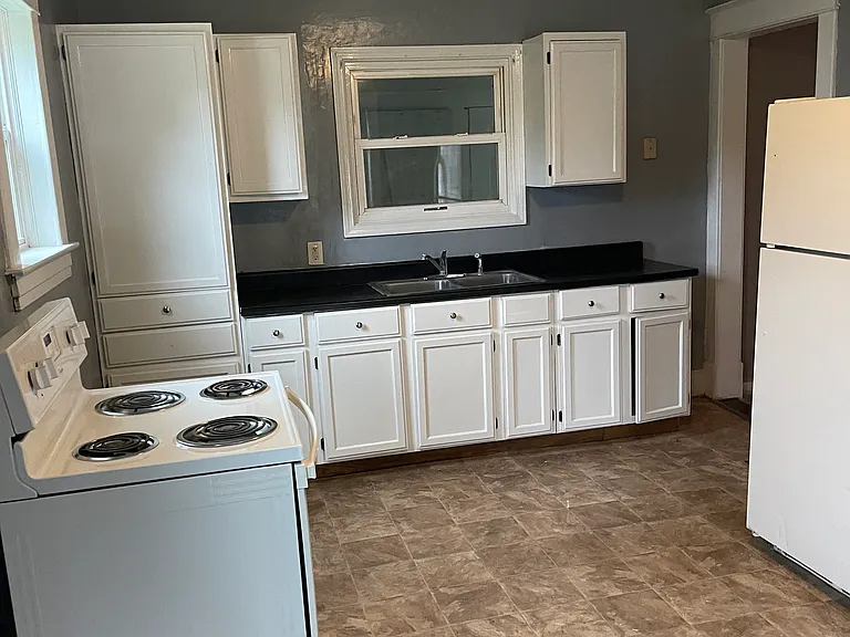 Kitchen taken from Dining Area. Kitchen Window looks out onto enclosed back porch.